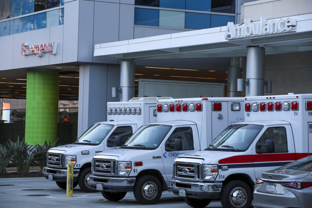 Three ambulances are lined up outside of an emergency room of a children's hospital in Orange, CA.