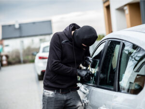 Car thief trying to break into a car