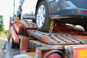 Broken car stands on tow truck closeup