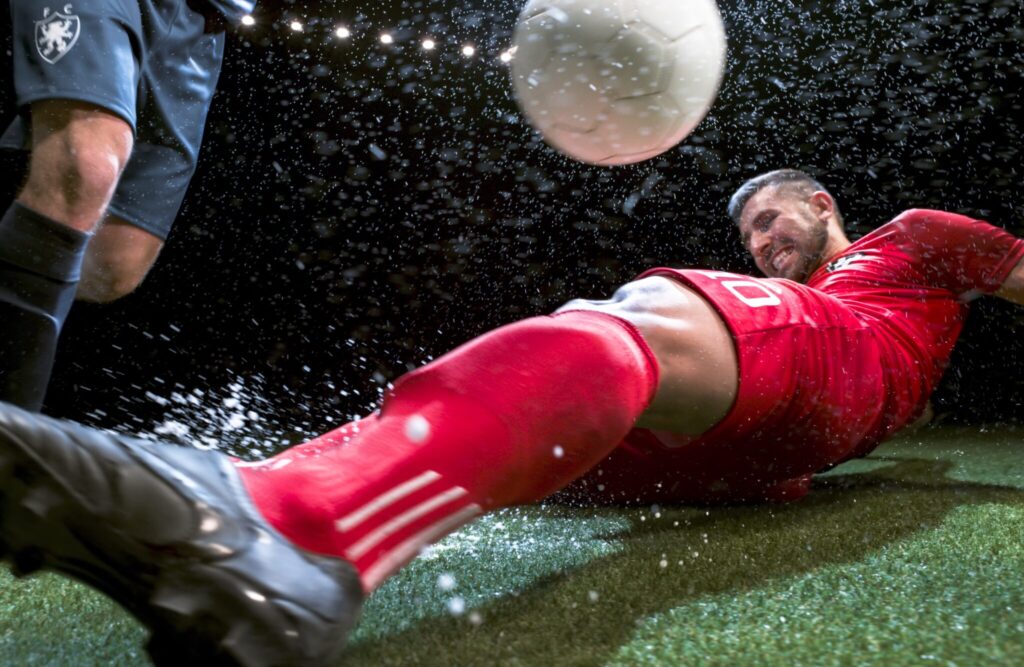 Soccer player trying to slide tackle his opponent