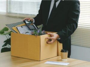 Businessman packing a box with desk items