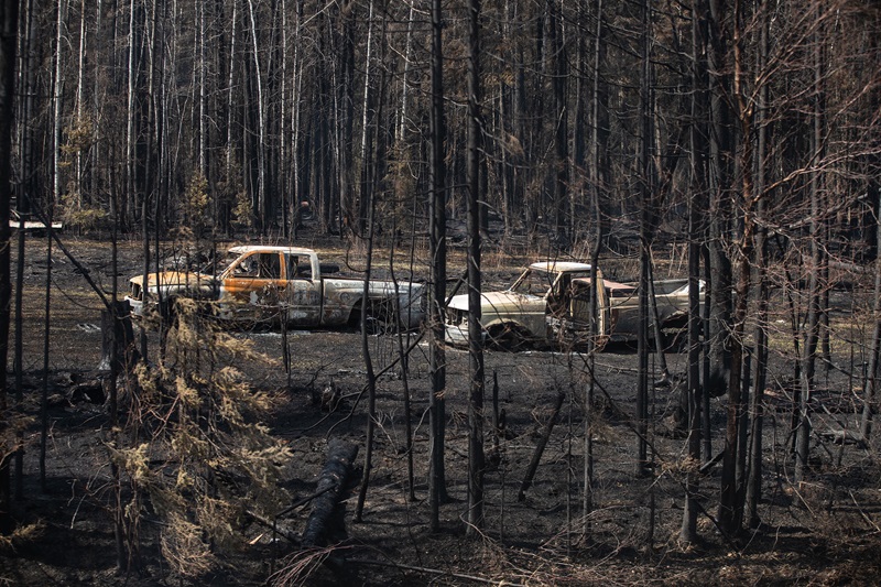Burnt out trucks from a wildfire in Drayton Valley, Alta. in May 2023