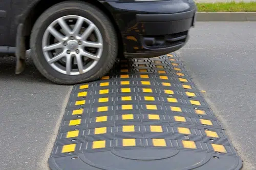 Car parked on a speed bump.