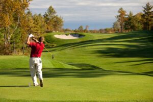 Senior Male Caucasian Golfer Driving off the Tee in Fall