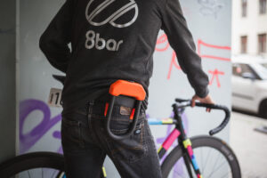 A bicycle rider wearing a Hiplok DX lock