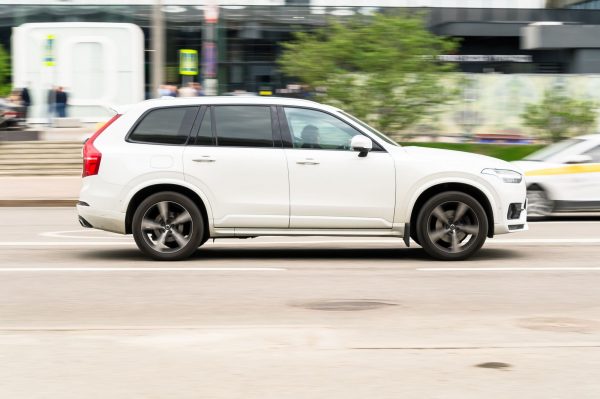 The Volvo XC90, an AWD, speeding along a road