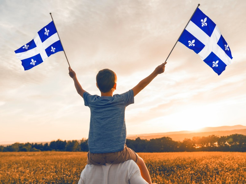 Child waving Quebec flags