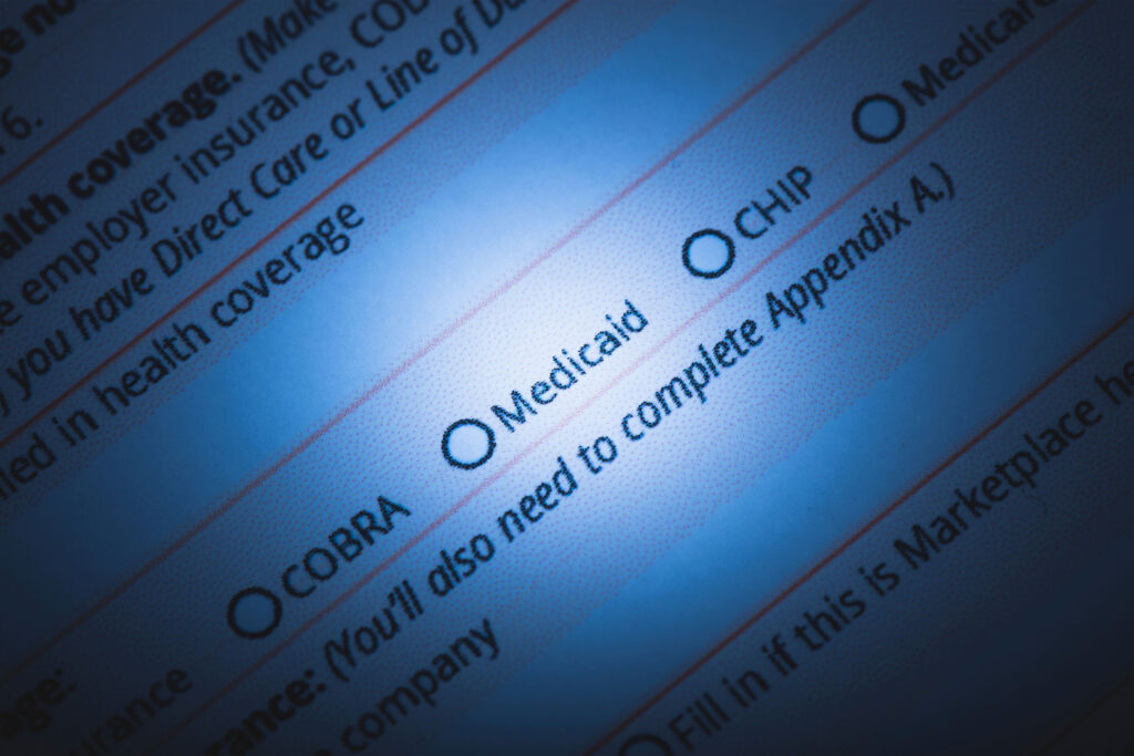 A photo of a health insurance form with a spotlight on "Medicaid."