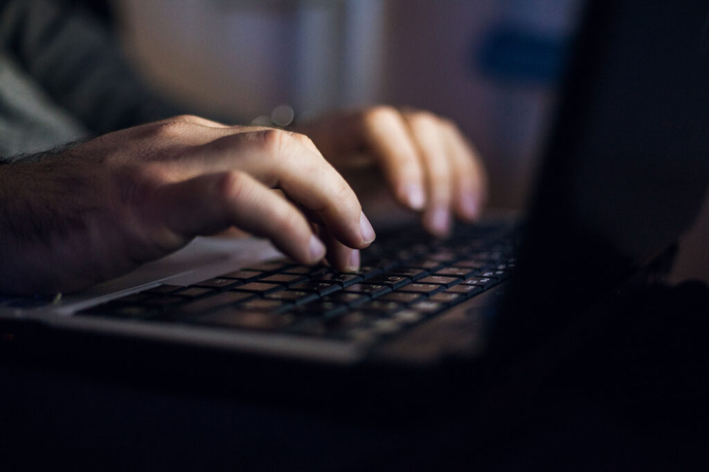 A close-up of shot of an hands typing on a computer keyboard.