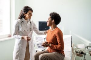 Female medical practitioner reassuring a patient