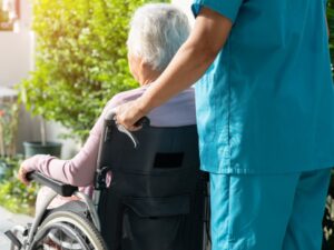 Caregiver at a long term care home with a patient.