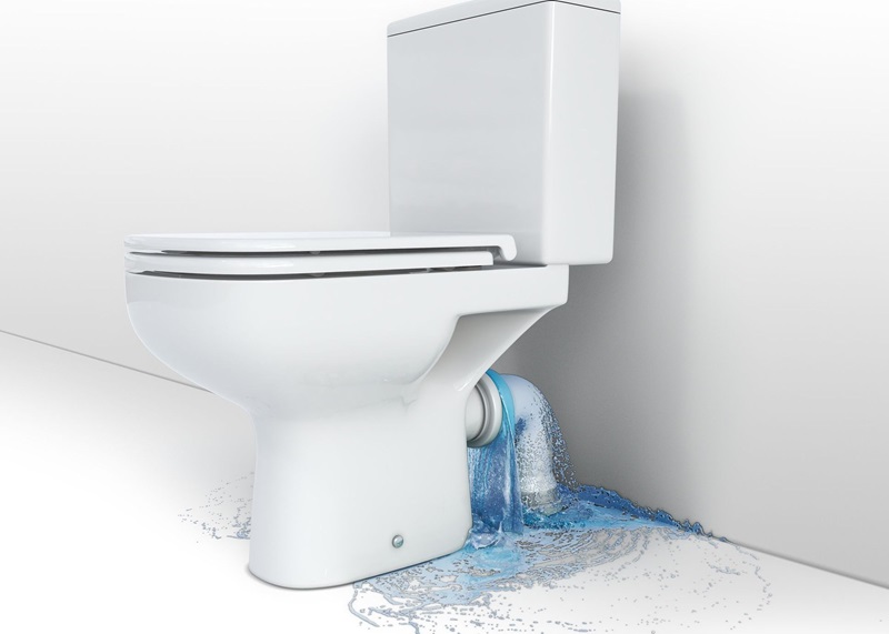 A leak under the toilet bowl splashing water