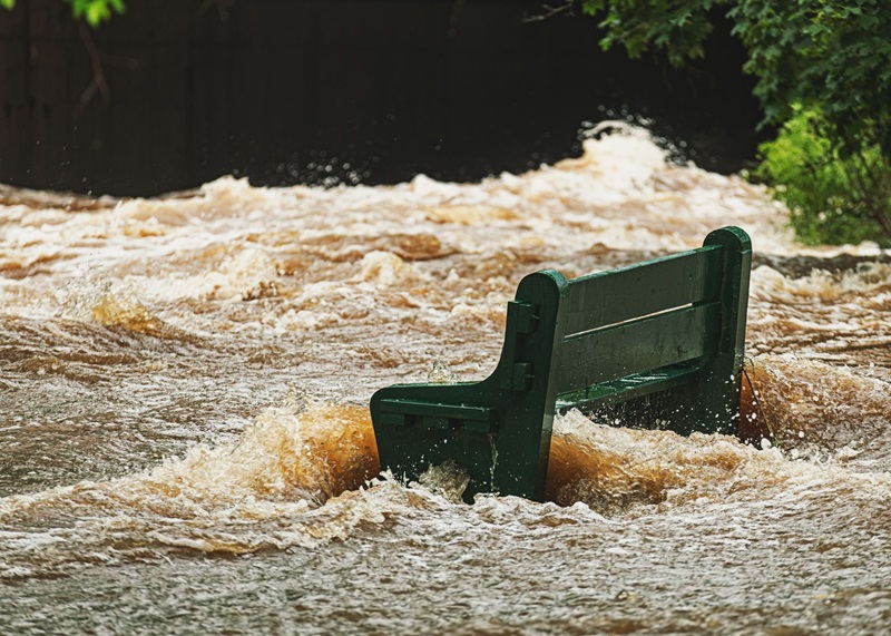 Flooded park bench after record rainfall in Nova Scotia