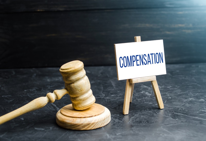 Compensation and judge's gavel. Award of moral financial compensation for caused damage. Lawyer services. Workers rights protection. Raising wages. Determination of payments by a court order.