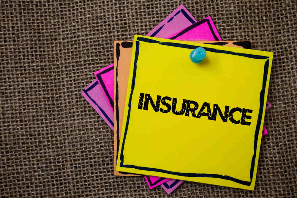 a pinned stack of brightly colored papers, the top one reading, "insurance"