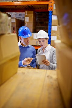 Inventory, stock and employees using tablet in distribution warehouse