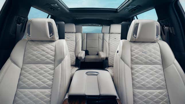 A photo looking back at all three rows of seats in the new Escalade with white leather 