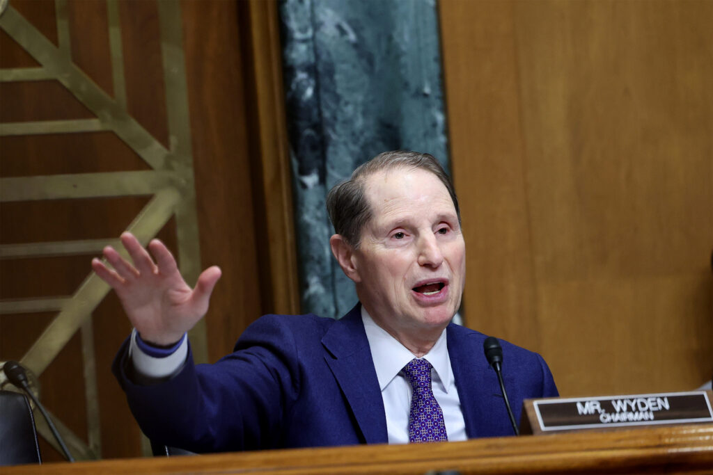 A photo of Senator Ron Wyden speaking inside a Senate committee room.