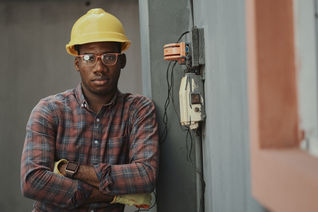 Electrician working on a circuit board - general liability insurance for electrical contractors