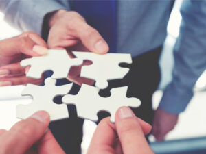 Group of business people holding a jigsaw puzzle