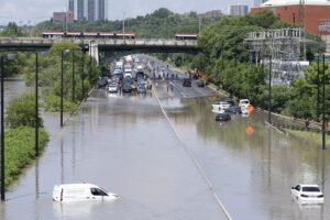 Cars are partially submerged in flood waters in the Don Valley following heavy rain in Toronto on July 16 2024. THE CANADIAN PRESS/Arlyn McAdorey