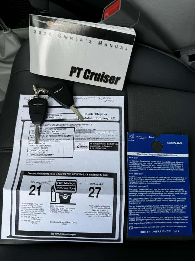 A photo of the original window sticker, manual, and keys