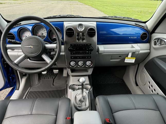 A photo of the front cabin of the blue PT cruiser