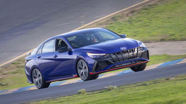 A photo of a blue Hyundai Elantra N on track. 