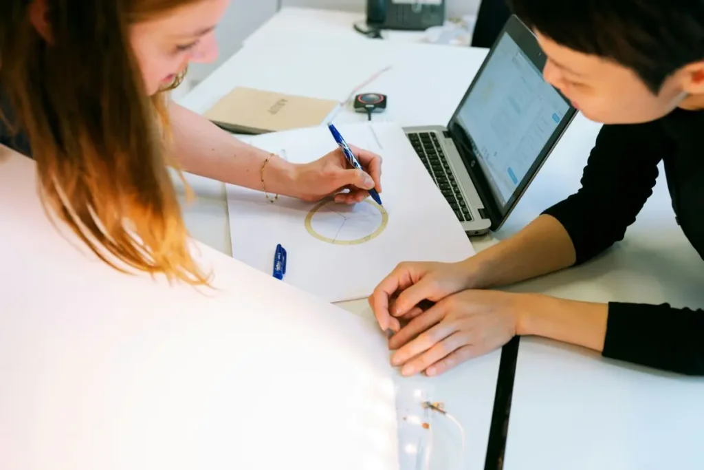 Female electrical engineer talking to a colleague