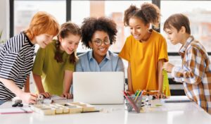 Teacher and students at the her computer.