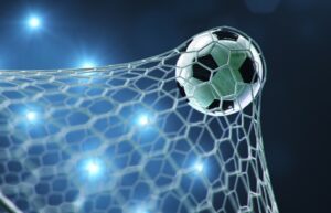 Soccer ball flew into the goal. Soccer ball bends the net, against the background of flashes of light. Soccer ball in goal net on blue background. A moment of delight, 3D illustration