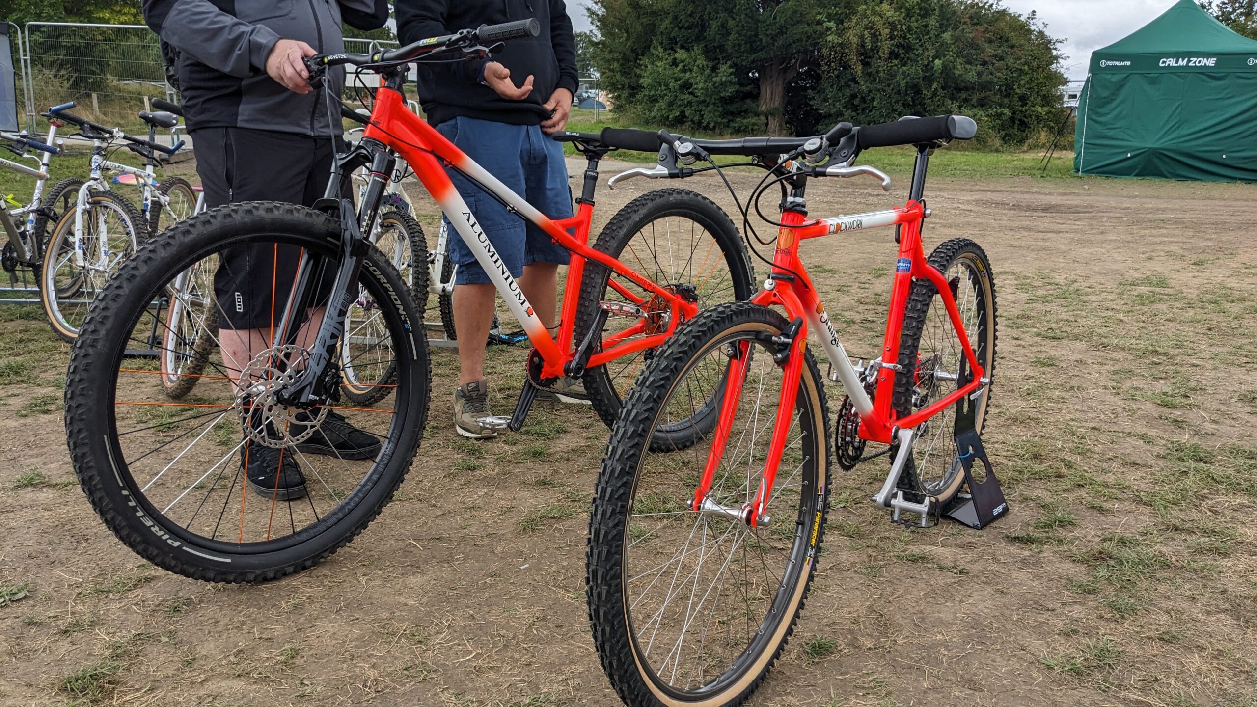 two Orange mountain bikes