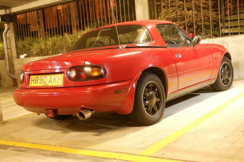 Red Mazda MX-5 in a car parking space