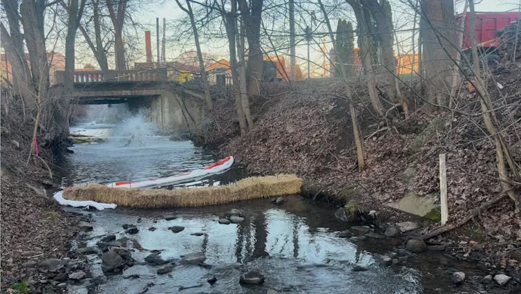 A creek with a device shooting water into the air by injecting air into the water.