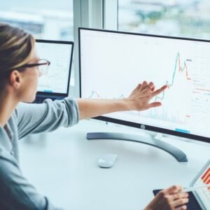 Business woman looking at stock chart, pointing