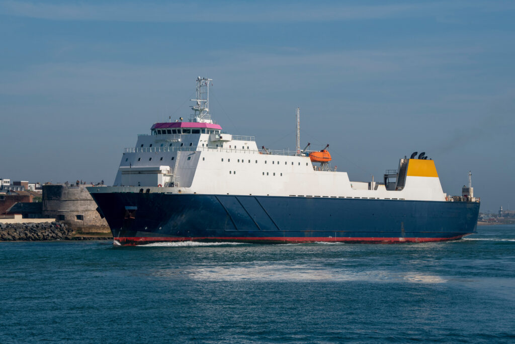 Freight ferry with cargo of trucks underway on ocean