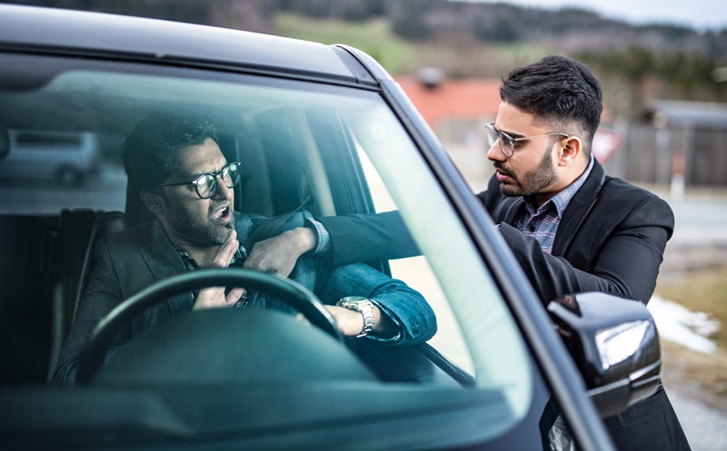 Angry man Attacking Another Driver Sitting In Car