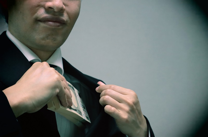 Image of a businessman stealing money