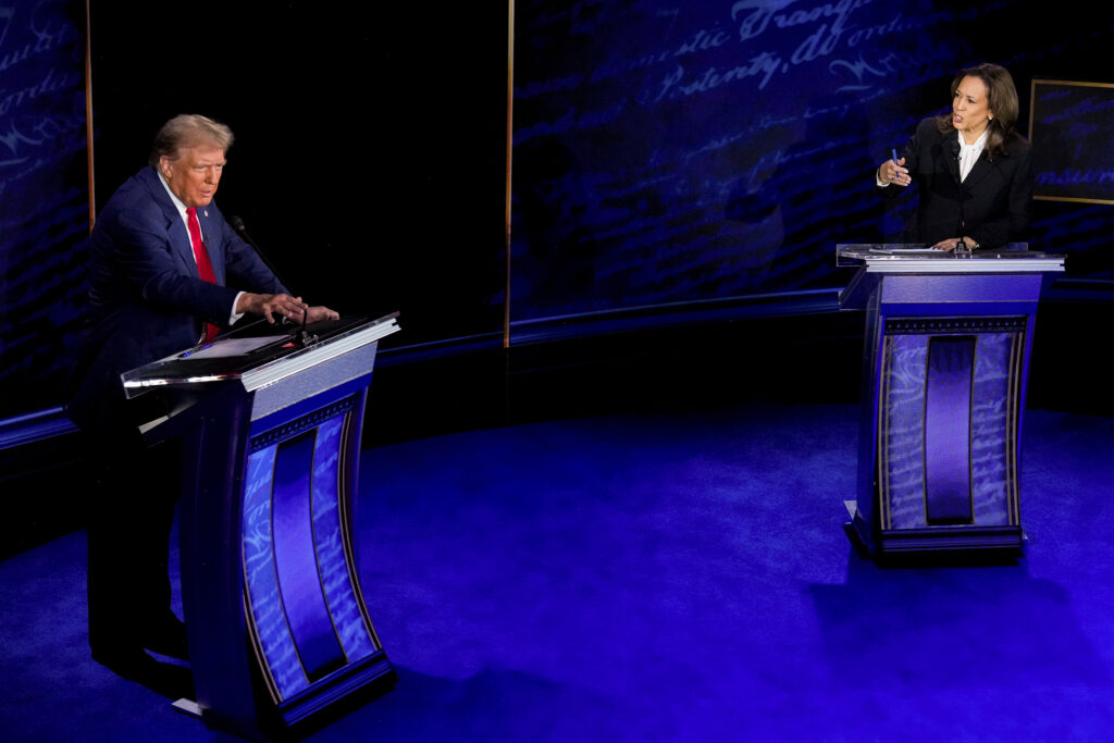 A photo of Kamala Harris and Donald Trump speaking from behind podiums on the debate stage.