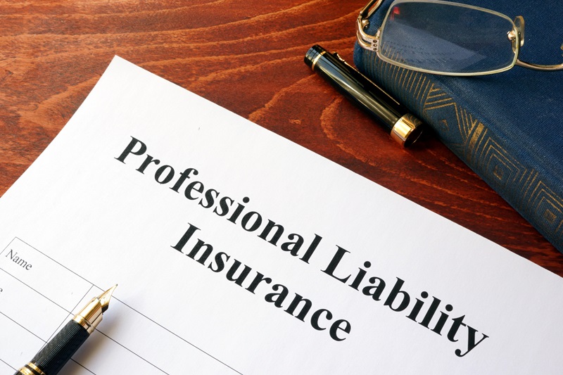 Professional liability insurance policy on a table.