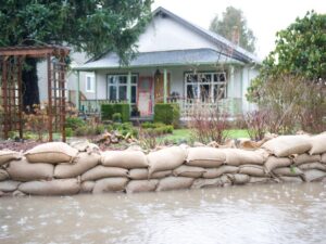 Flooded house protected by sandbags.