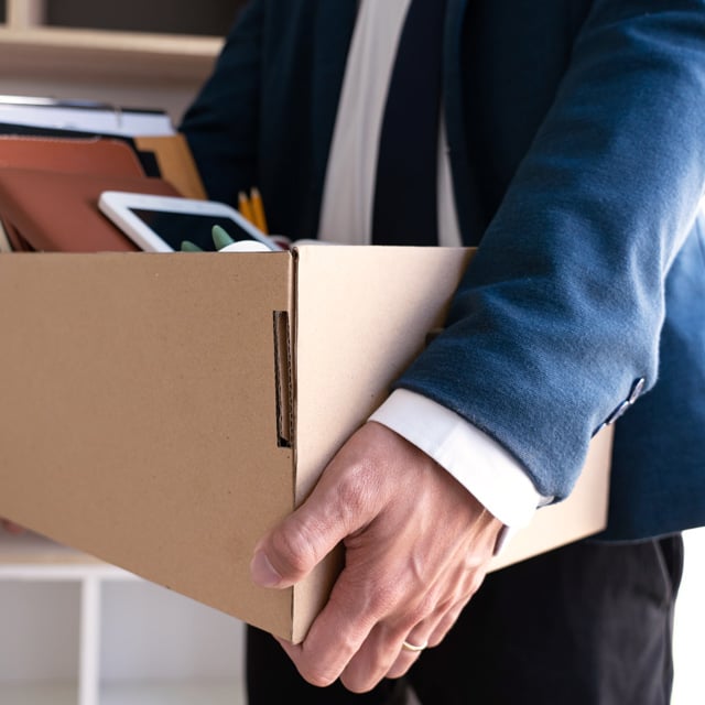 Employee moving belongings out of an office