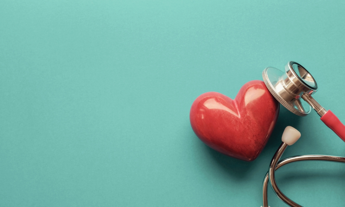 a glazed clay heart with a stethoscope's listening part on it