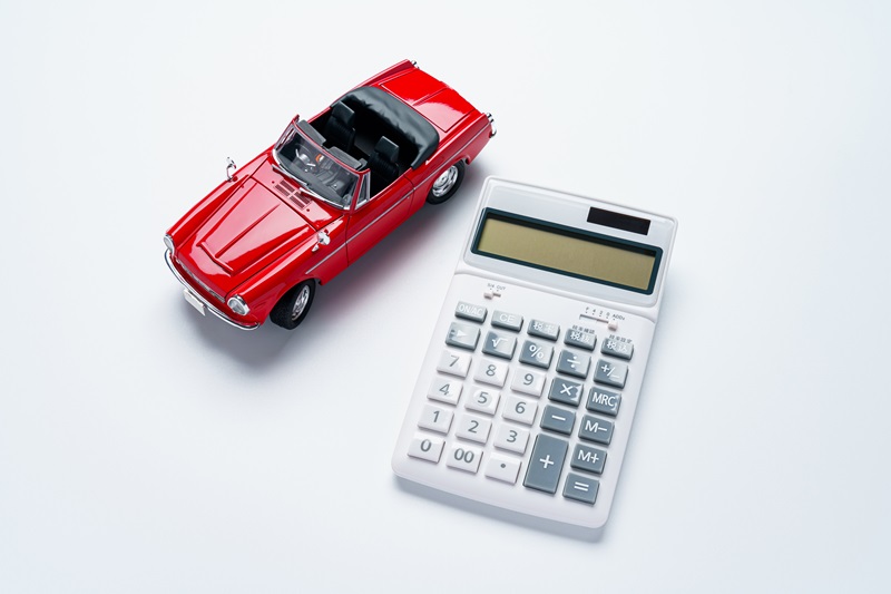 Calculator and sports car isolated on white background