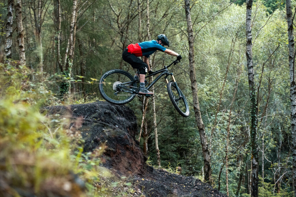 Mountain biker riding off a ledge