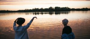 Girlfriends throwing stones in river water